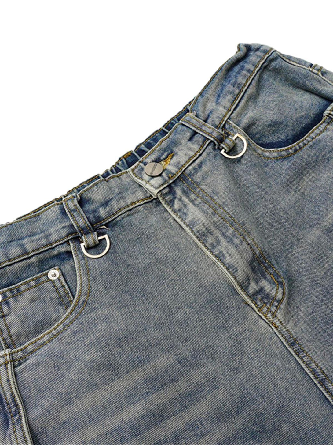 Detailed look at TALISHKO's washed distressed barrel jeans, highlighting the unique D-ring details.