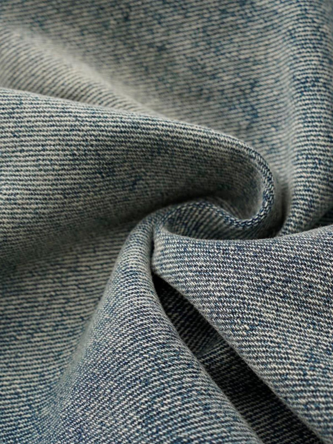Texture and pattern showcased in TALISHKO's washed distressed deconstructed jeans fabric.