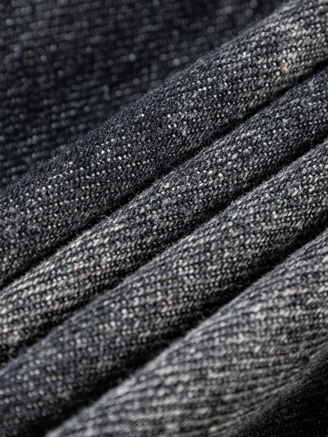 "Texture and pattern showcased in TALISHKO's washed distressed denim jacket, highlighting fabric detail."