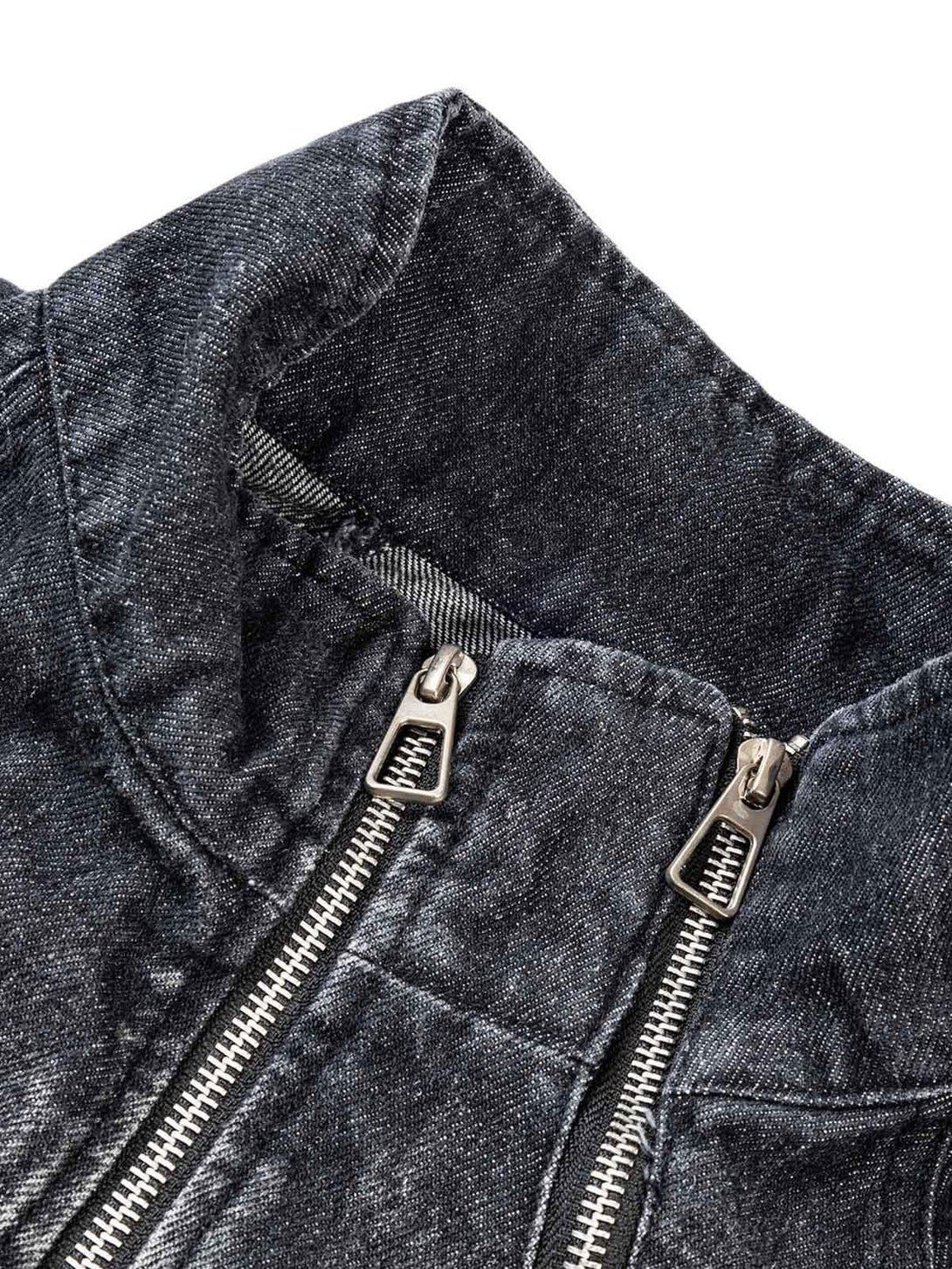 A detailed view of the washed distressed denim jacket by TALISHKO, highlighting the zipper design.