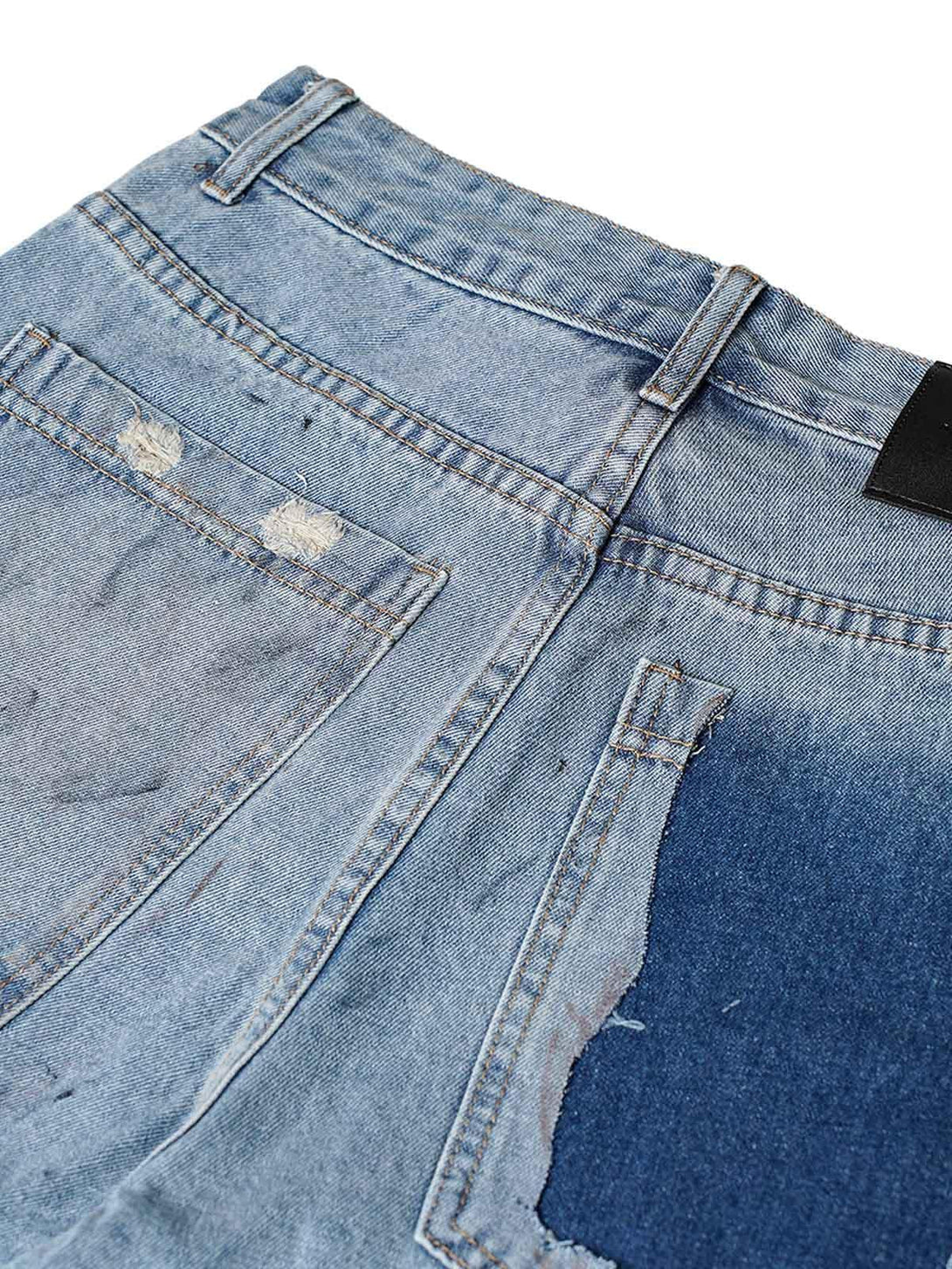 A detailed view of TALISHKO denim shorts highlighting distressed pockets and unique texture.