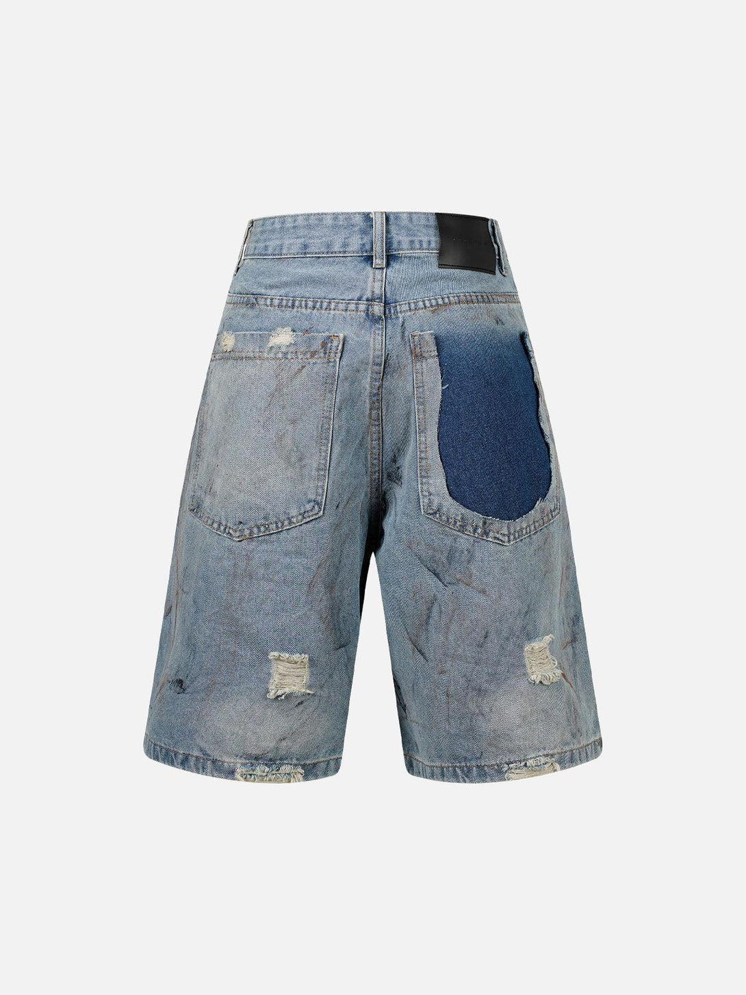 Back view of TALISHKO distressed denim shorts featuring ripped details and a unique patchwork design.