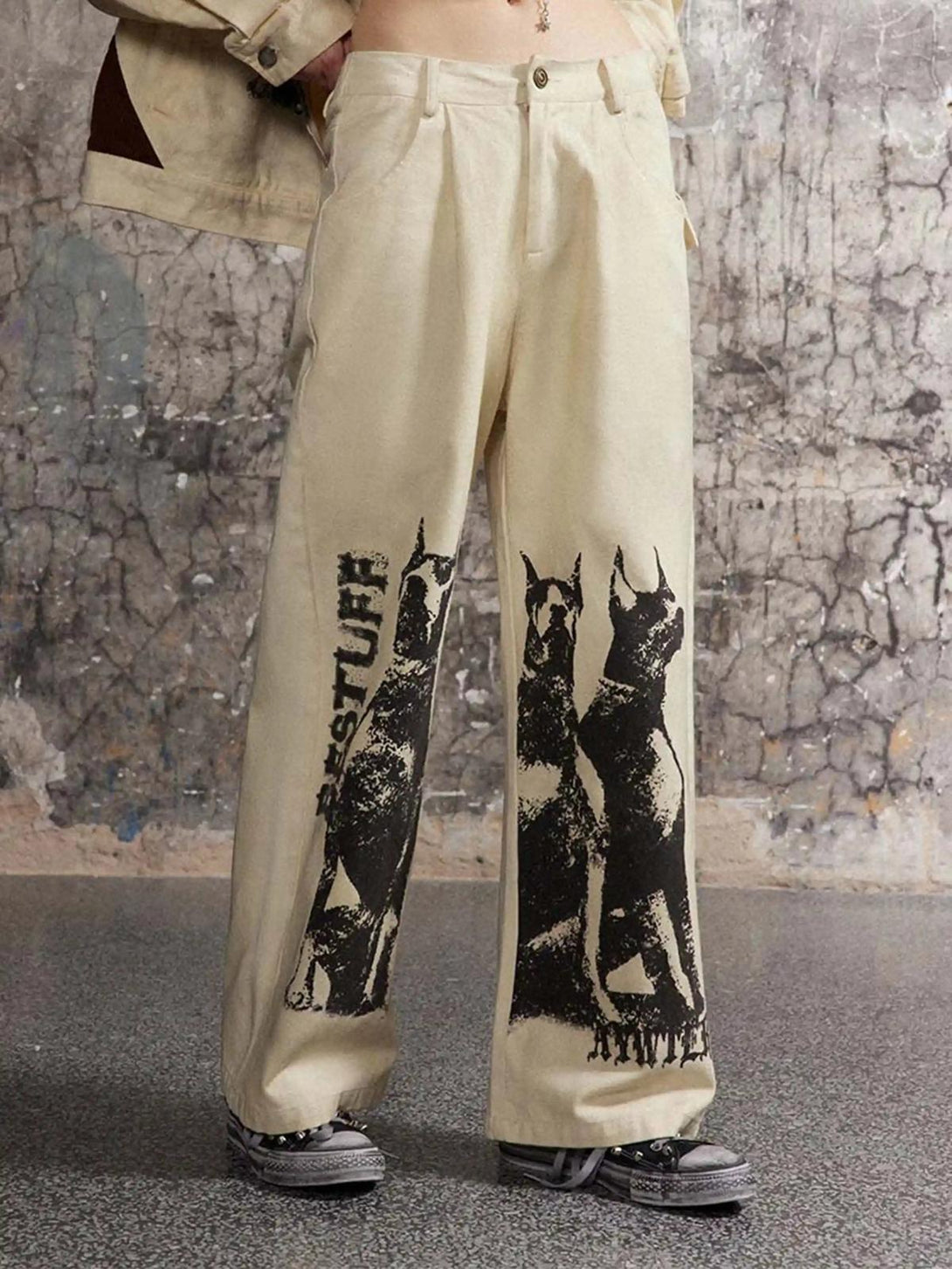 Wide-leg sweatpants with Doberman graffiti by TALISHKO, capturing an edgy street vibe.