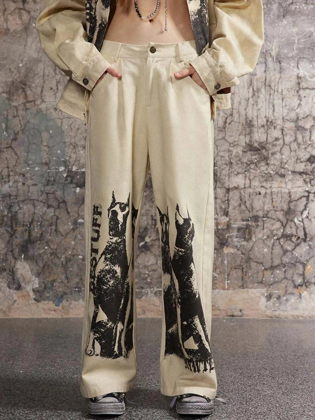 Model wearing TALISHKO sweatpants with Doberman graffiti, highlighting urban streetwear style.