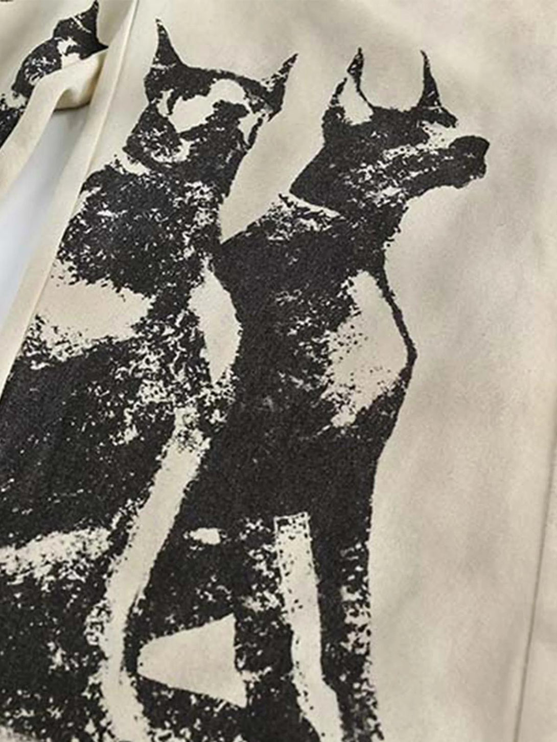 A close-up of TALISHKO sweatpants showcasing Doberman graffiti design, emphasizing urban fashion.