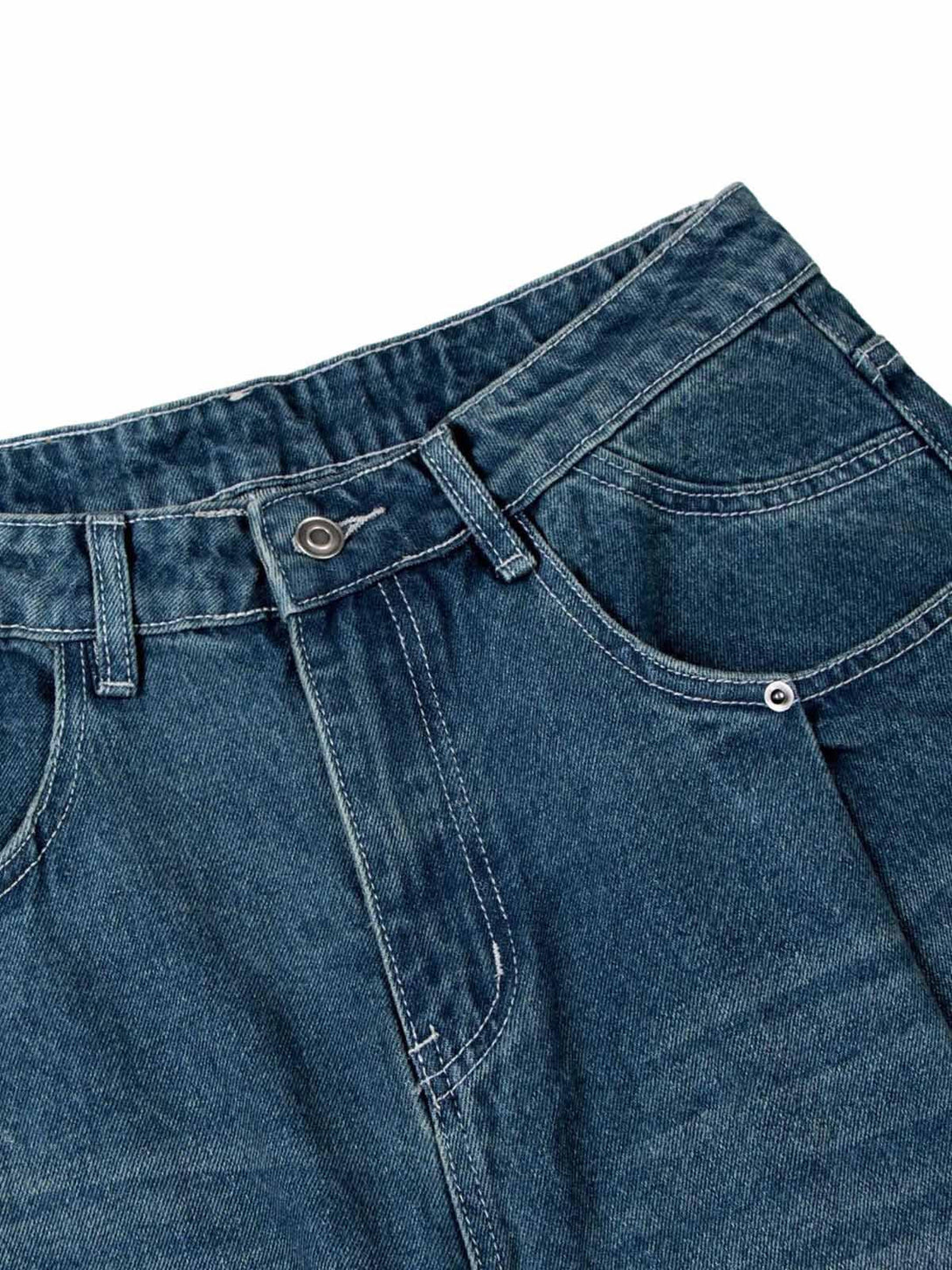 Detailed fabric and stitching on TALISHKO's washed distressed double pleat jeans.