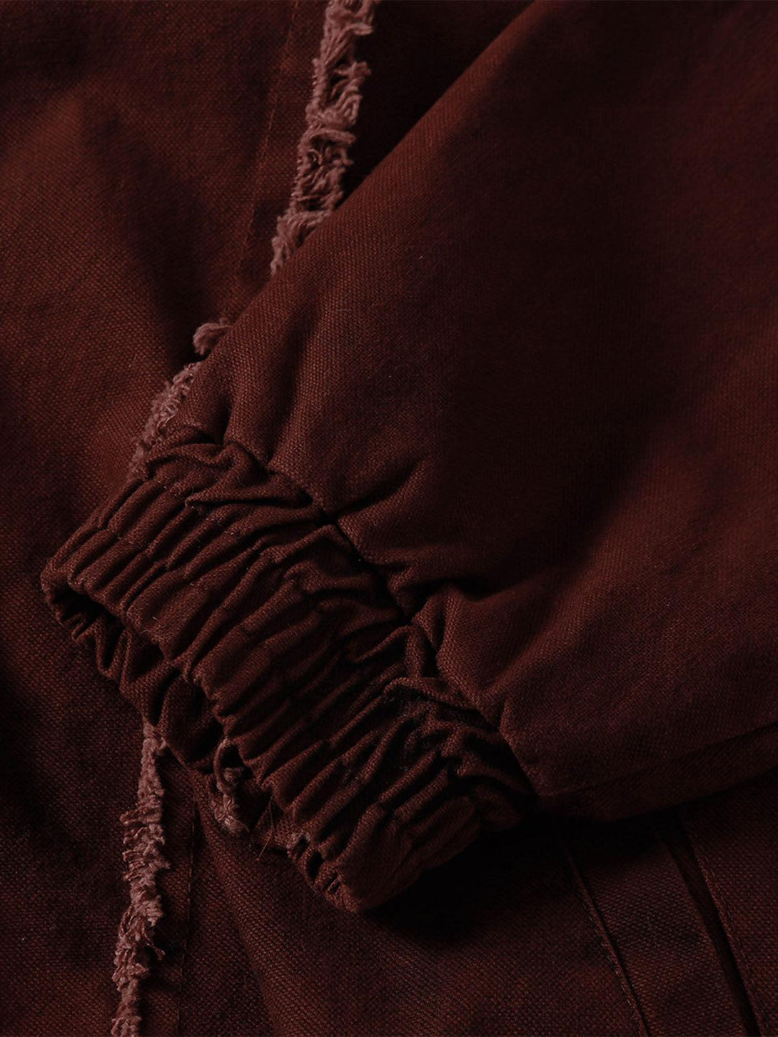 Detailed view of the washed distressed cuff on a jacket by TALISHKO, showcasing rugged style.