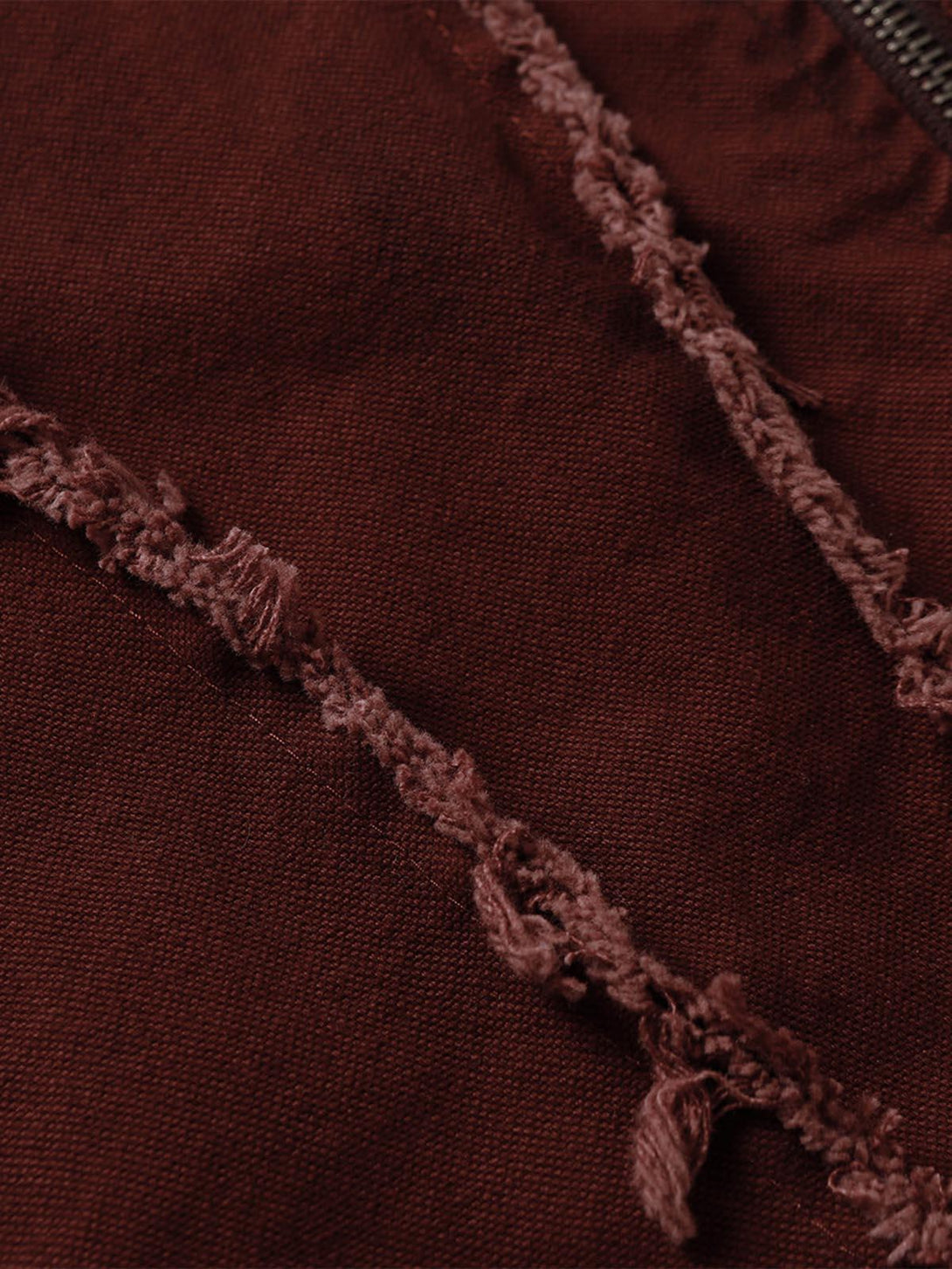 Intricate look at the frayed stitching on a washed distressed jacket by TALISHKO.