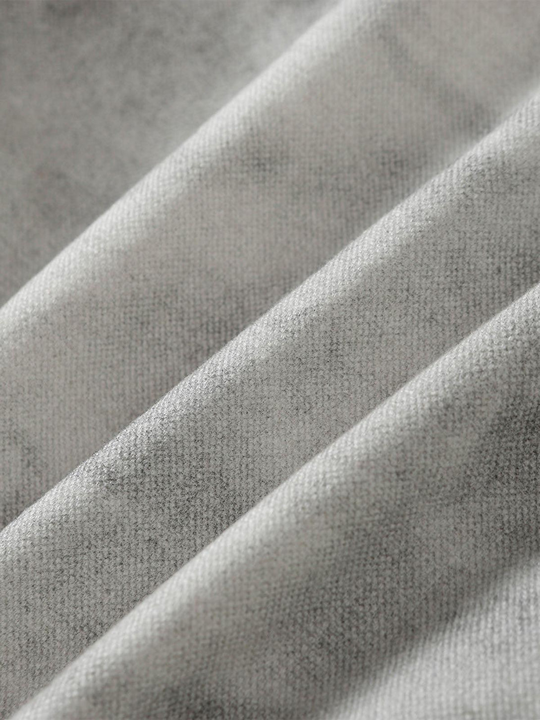 Focusing on the washed distressed texture of TALISHKO's jacket, highlighting its unique fabric.