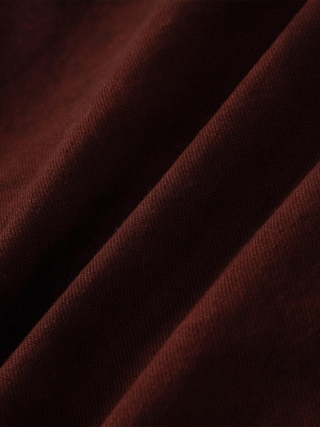 Texture and pattern showcased in a washed distressed fabric by TALISHKO, highlighting its rich color.