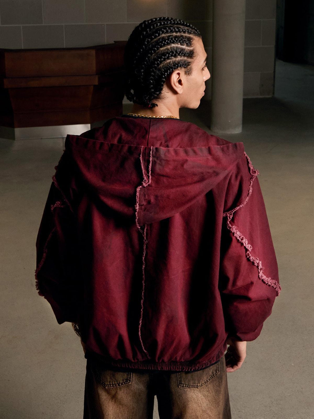 Rear view of a red washed distressed jacket by TALISHKO, highlighting rugged urban fashion.
