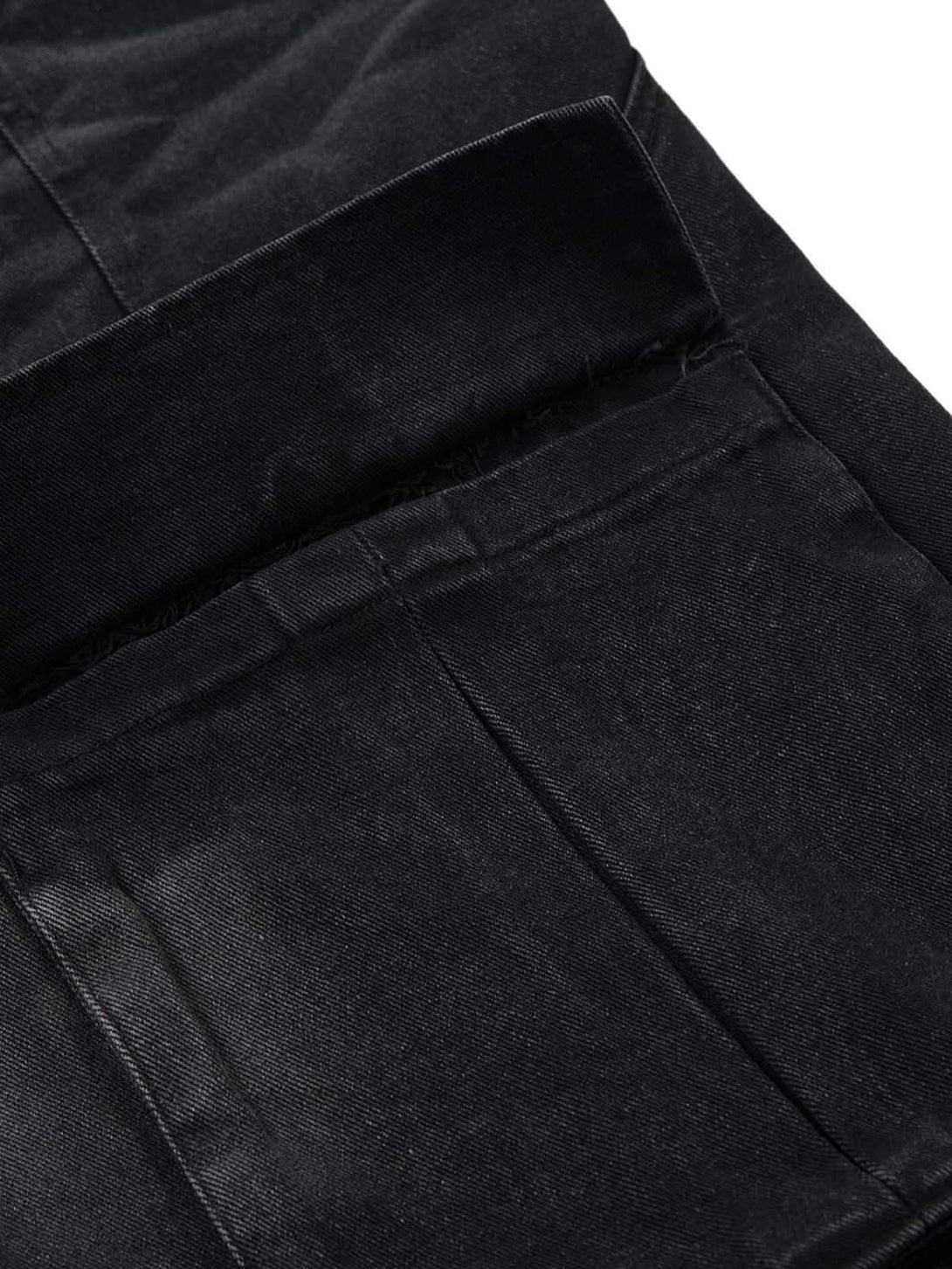A close-up of TALISHKO's black washed distressed cargo jeans, highlighting the pocket detail.