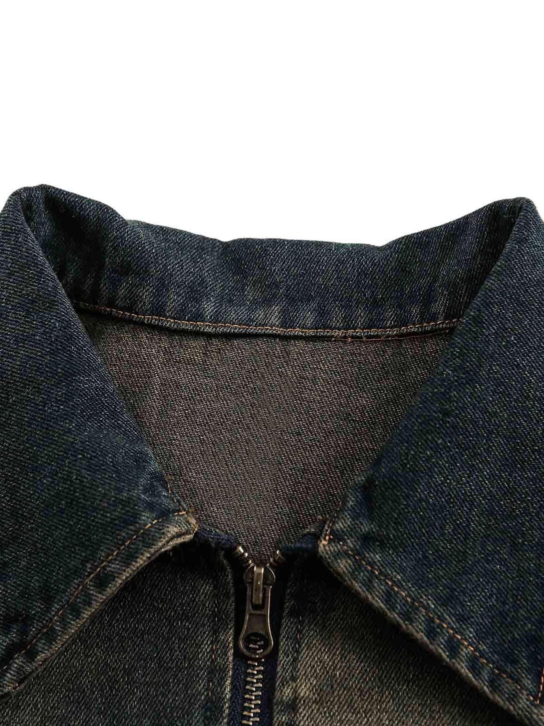 A detailed look at the collar and zipper of a TALISHKO washed distressed denim jacket.