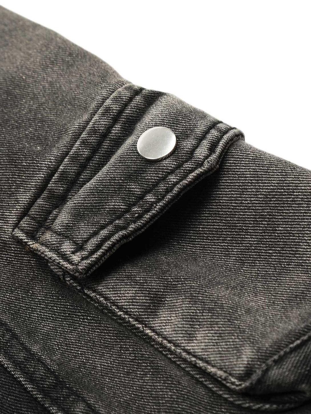 A close-up of TALISHKO's washed cargo jeans, highlighting the button detail on the pocket.