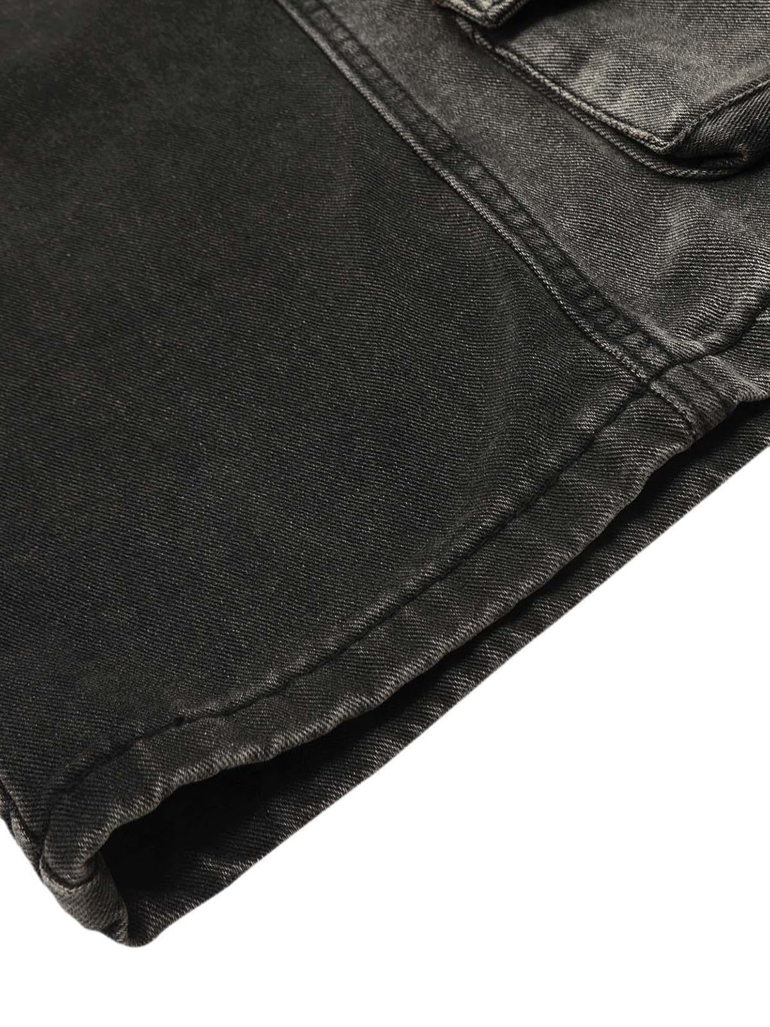 Detailed look at TALISHKO's washed cargo jeans, highlighting the hem and pocket stitching.