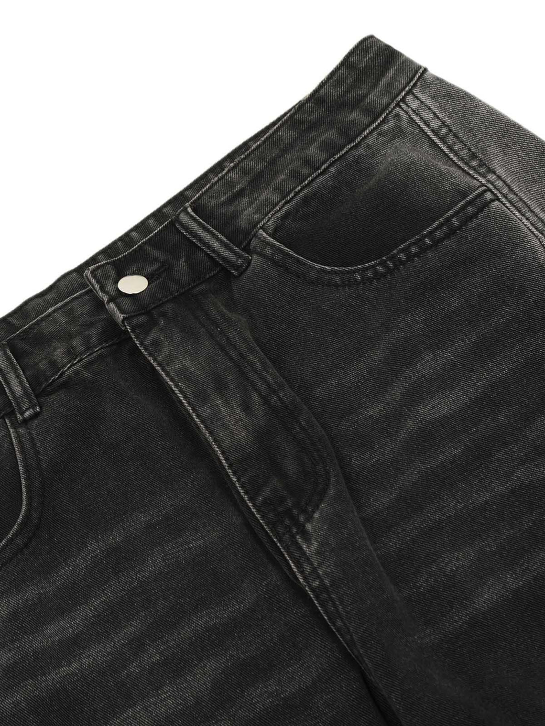 Detailed fabric and stitching of black washed cargo jeans with a distressed look by TALISHKO.