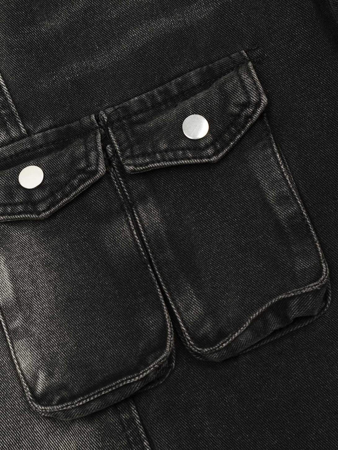 Intricate look at TALISHKO's washed distressed cargo jeans, focusing on the front pocket details.
