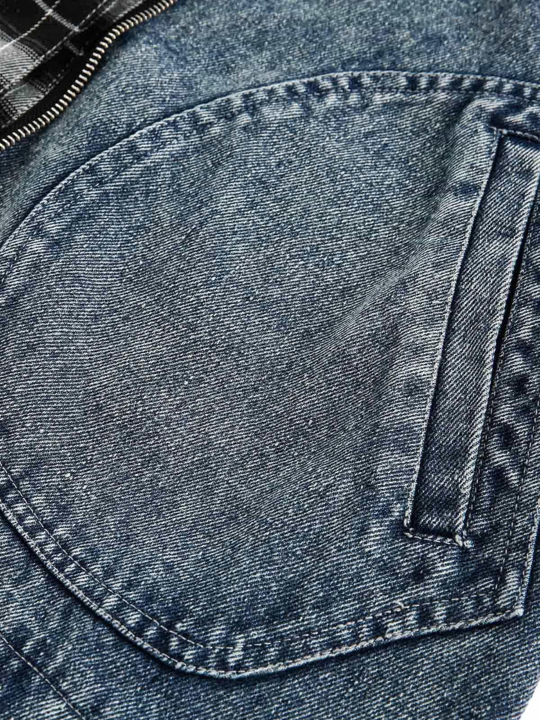 Intricate look at TALISHKO's washed denim jacket, highlighting patchwork and faux two-piece design.