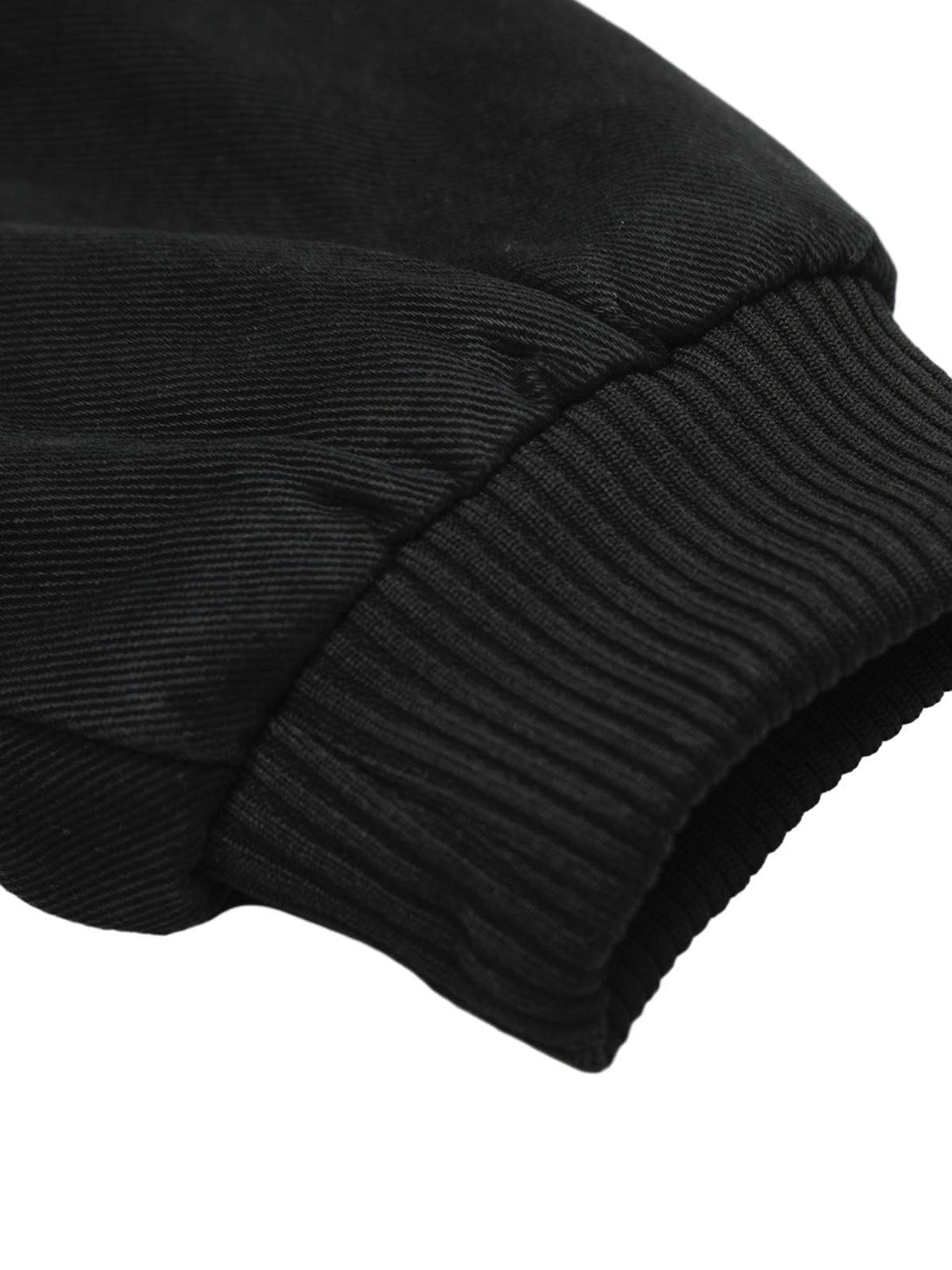 Detailed look at TALISHKO's black jacket cuff, highlighting the ribbed texture and sleek design.