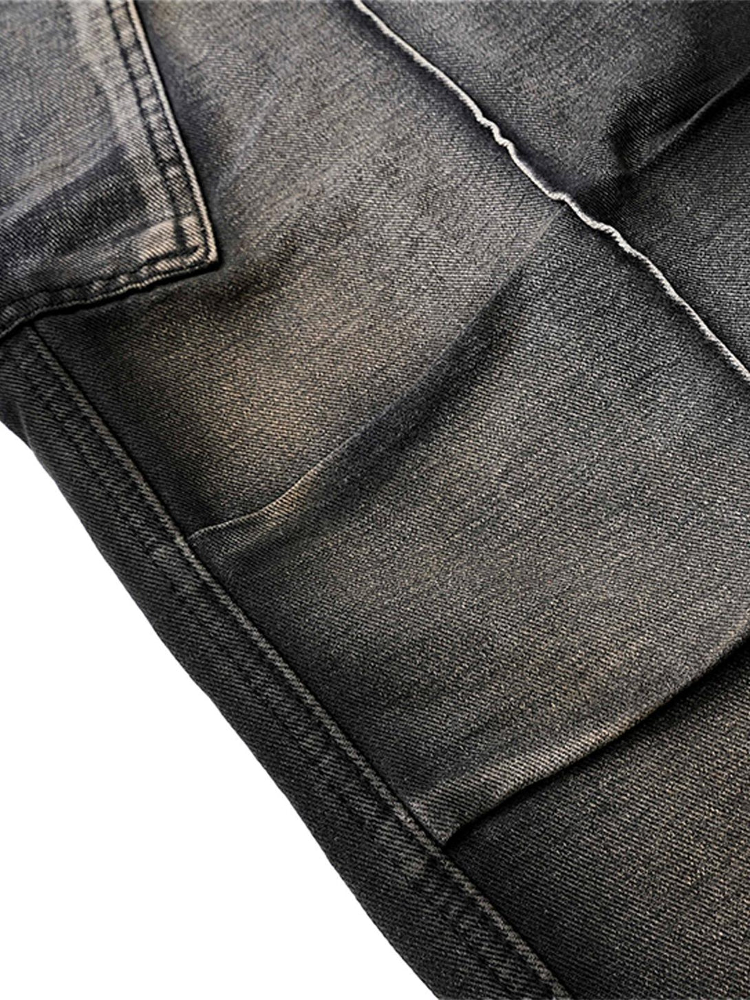 Detailed view of TALISHKO's washed distressed cargo jeans, focusing on fabric texture.