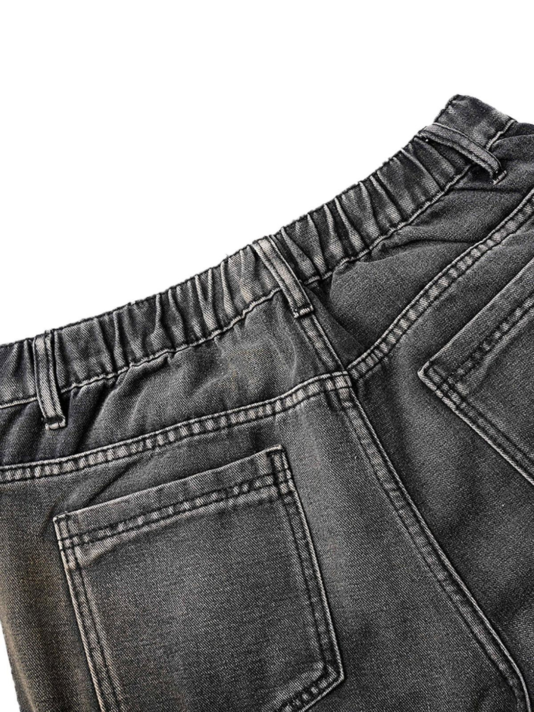 Detailed view of TALISHKO washed distressed pleated cargo jeans, highlighting back pockets.