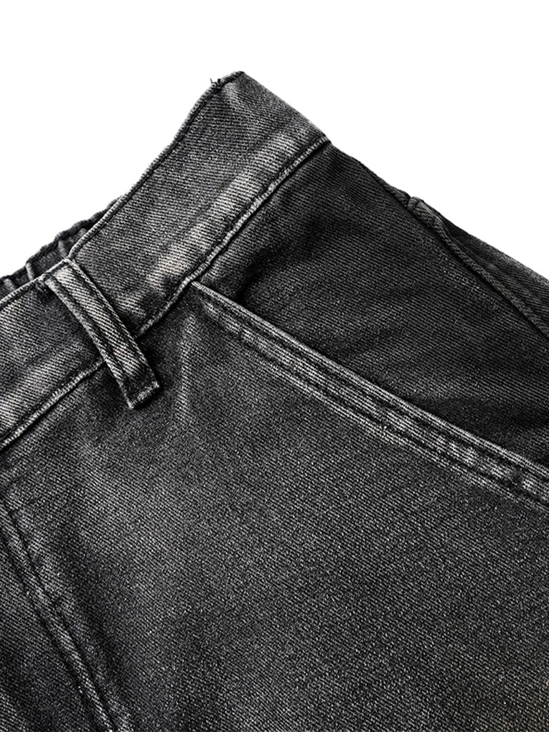 Detailed fabric and stitching of TALISHKO's washed distressed pleated cargo jeans.