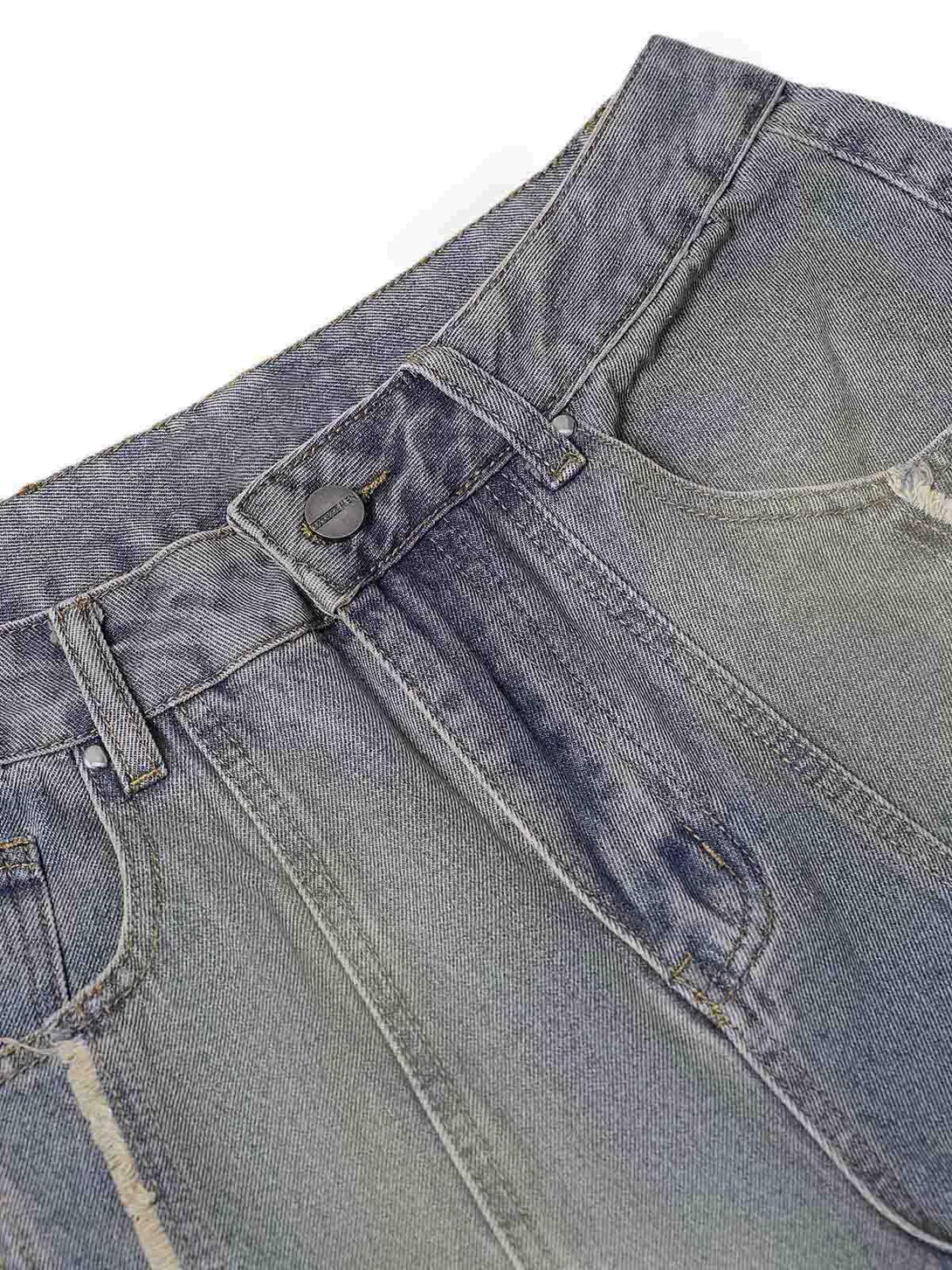 Detailed fabric and stitching on TALISHKO baggy jeans, highlighting the washed, distressed texture.
