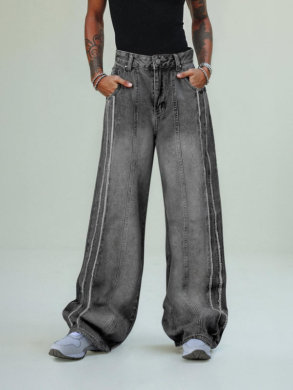 TALISHKO baggy jeans with washed, distressed raw edges worn by a model in a casual style.