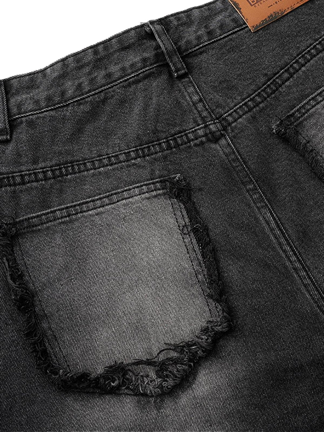 Close-up of TALISHKO's barrel jeans back view, featuring distressed pockets and raw edges.