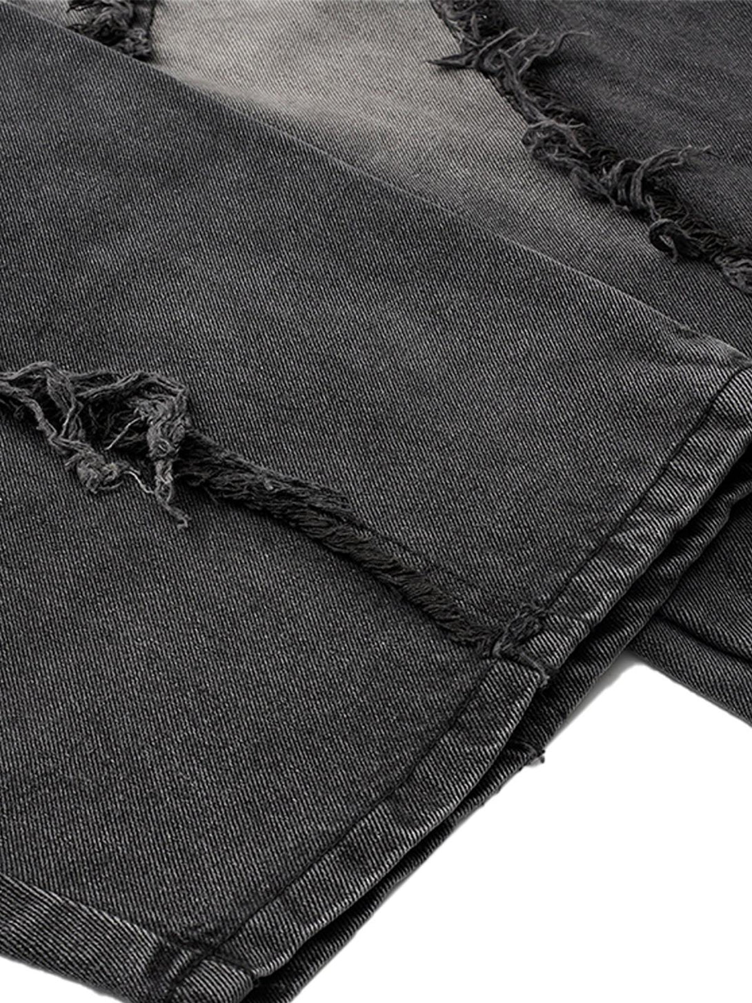 Intricate look at TALISHKO's distressed barrel jeans, showcasing raw edge and textured fabric.