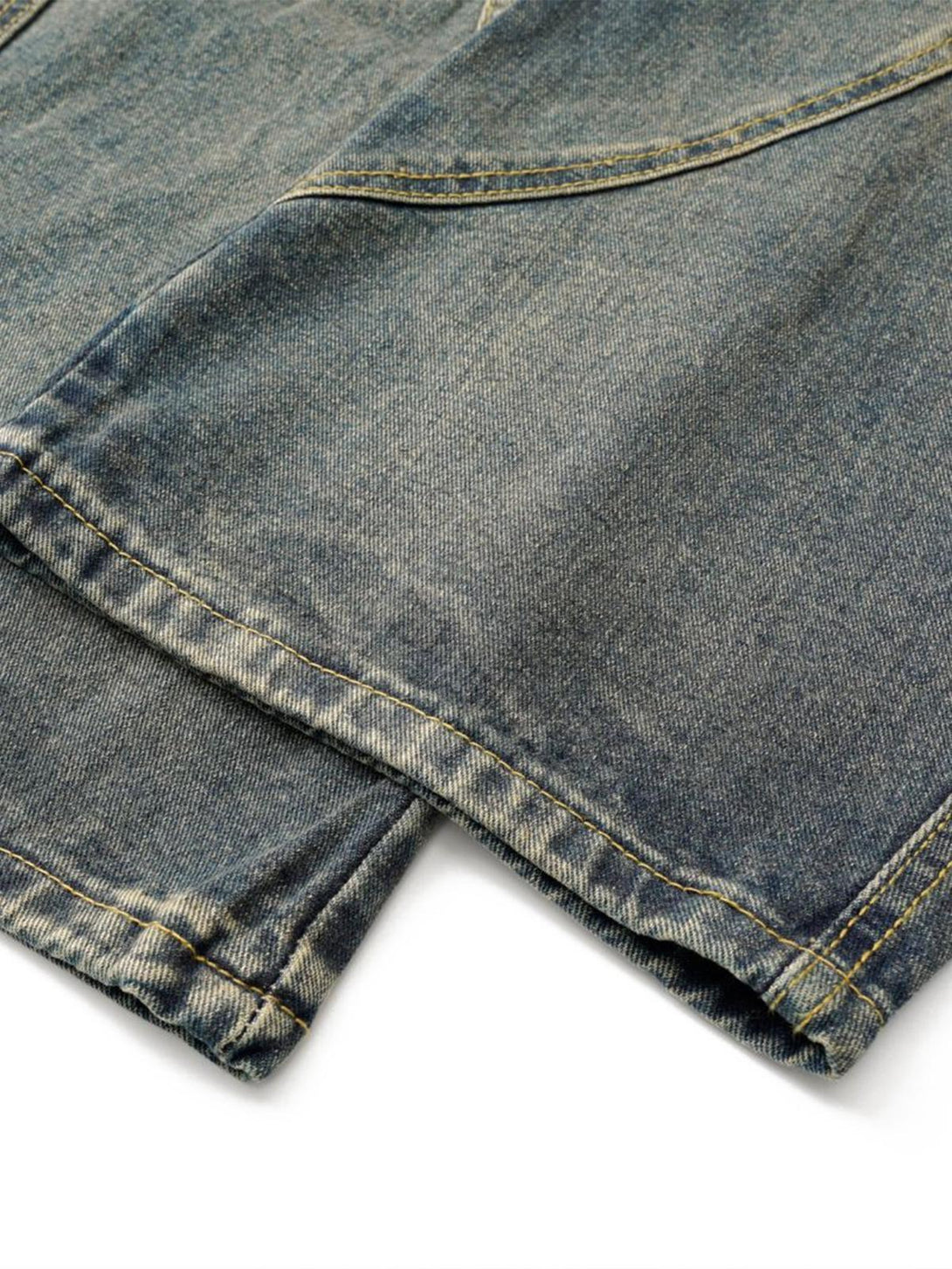 A close-up of TALISHKO barrel jeans, highlighting the washed distressed fabric and stitching.