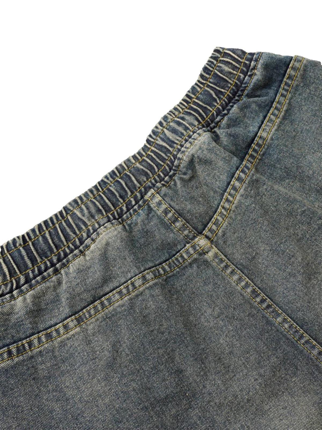 Detailed stitching and texture of TALISHKO barrel jeans, highlighting the elastic waistband.