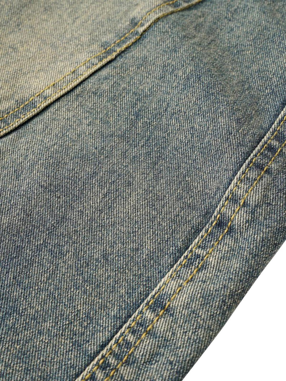 Intricate look at TALISHKO barrel jeans' washed texture and detailed stitching.