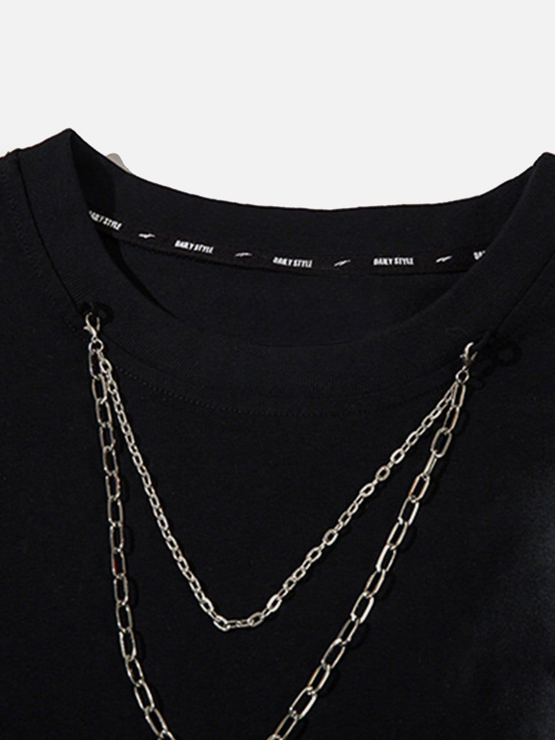 A close-up of TALISHKO's black distressed tee highlighting chain detail and neckline design.
