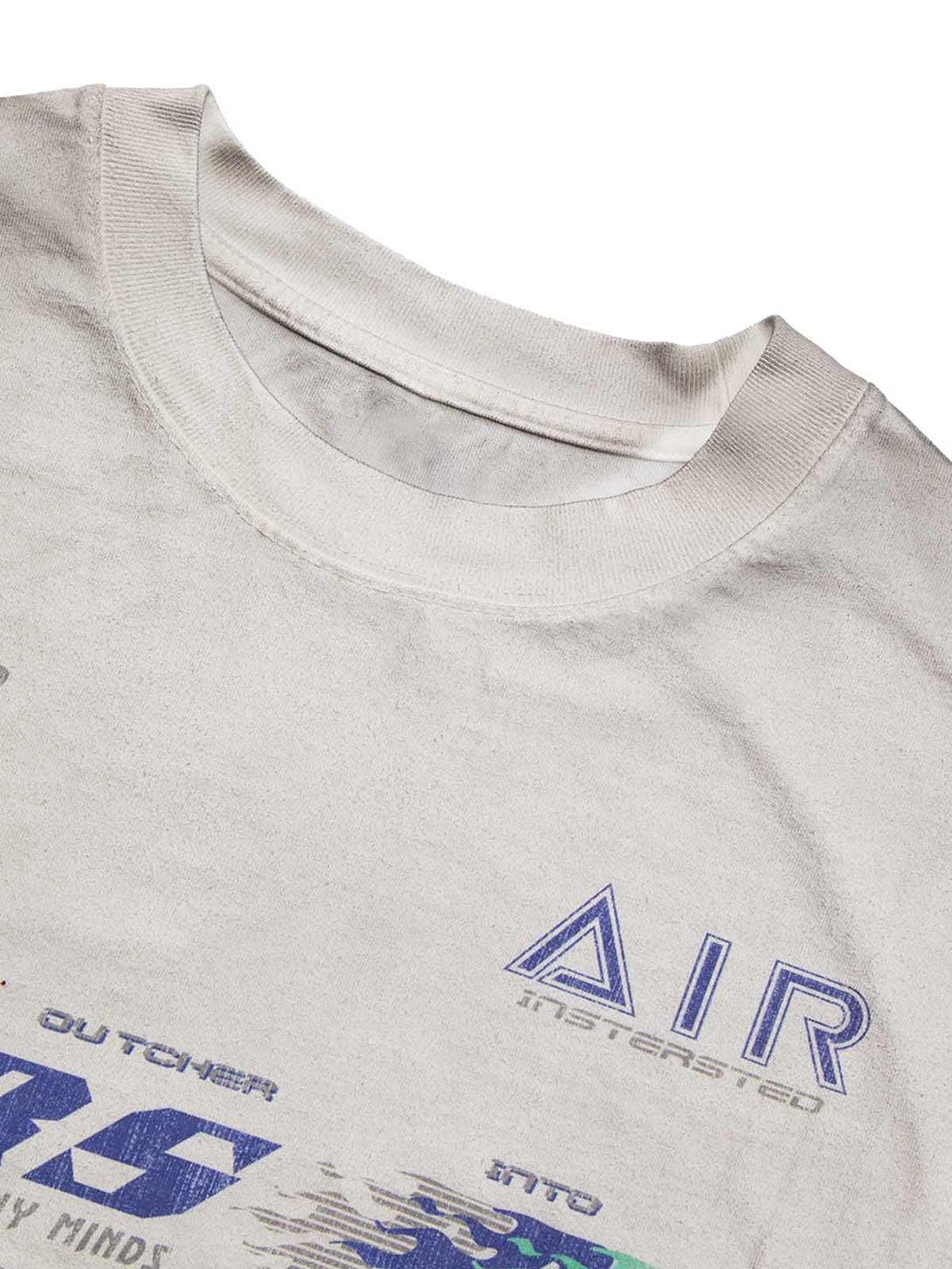 A tight crop highlighting the washed-edge long sleeve T-shirt by TALISHKO with graphic accents.