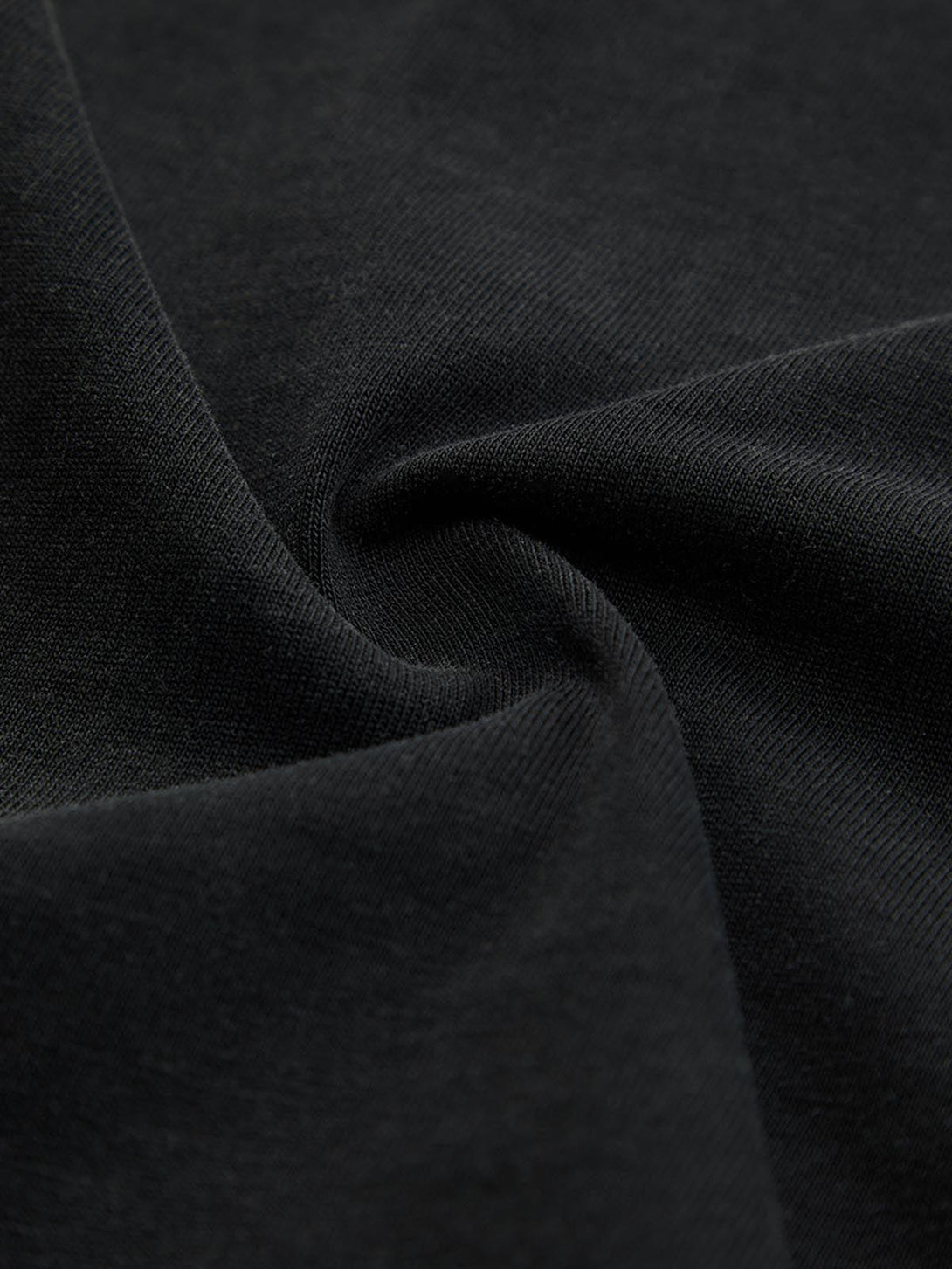 Intricate look at the washed-edge long sleeve T-shirt fabric by TALISHKO, showcasing texture.
