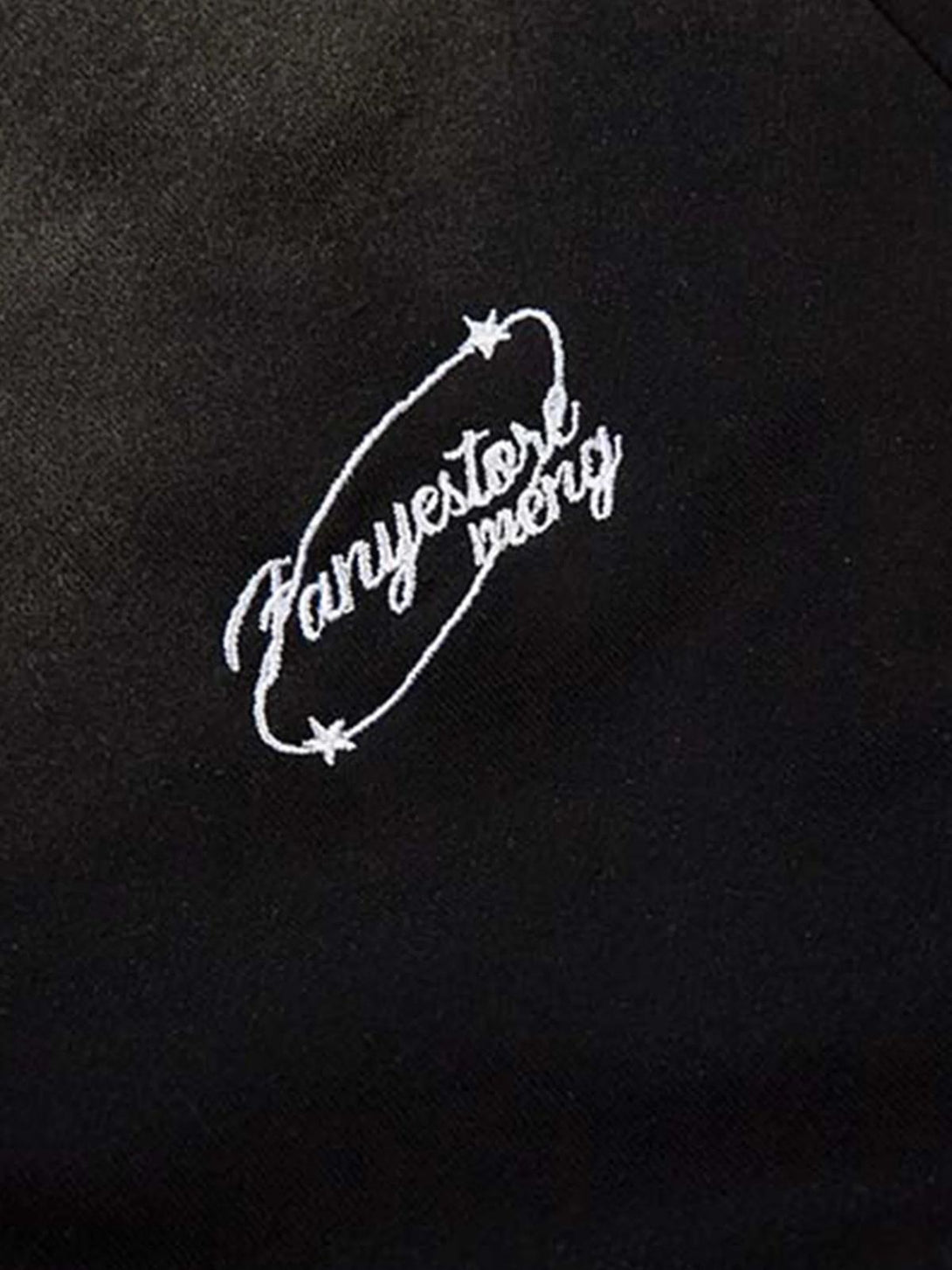 Intricate look at TALISHKO's embroidery detail on black fabric, highlighting unique design.