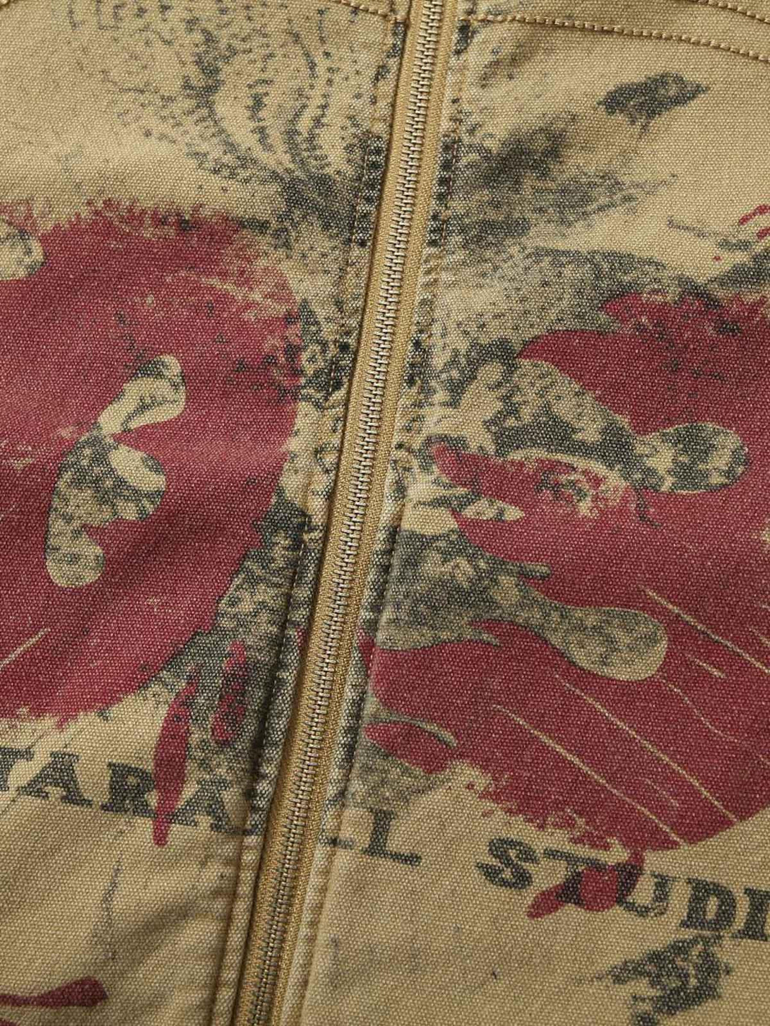 Intricate graffiti pattern on TALISHKO's washed workwear jacket, highlighting unique style.