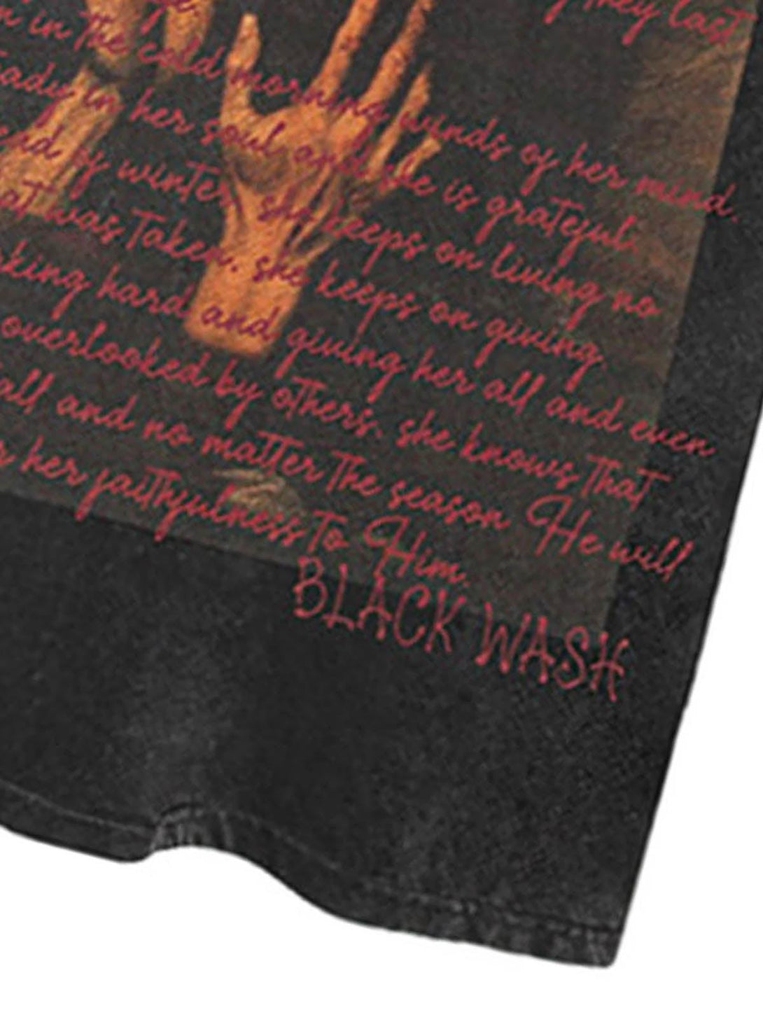 "Zoomed-in detail of a TALISHKO washed graphic T-shirt, showcasing intricate text and imagery."