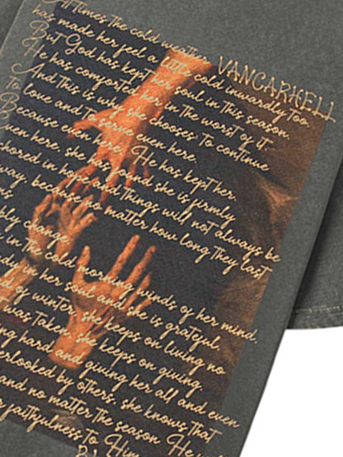 Zoomed-in view of a TALISHKO crew neck T-shirt, featuring intricate text and hand imagery.