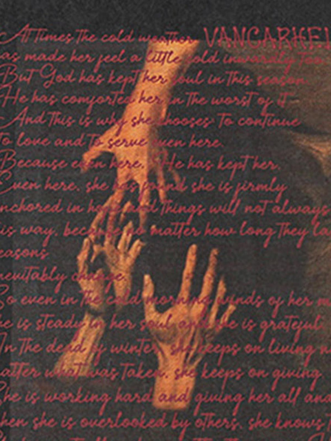 A detailed view of the washed graphic design on a TALISHKO crew neck T-shirt, highlighting intricate text and imagery.