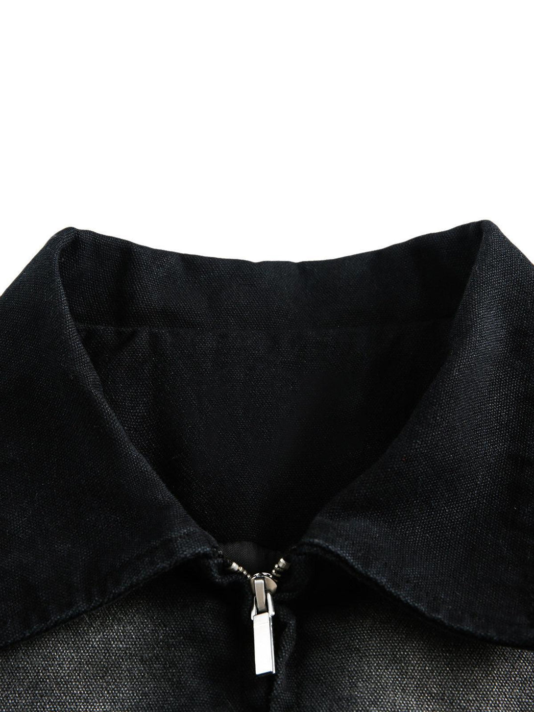 A detailed view of the TALISHKO denim jacket collar, showcasing its sleek zipper design.