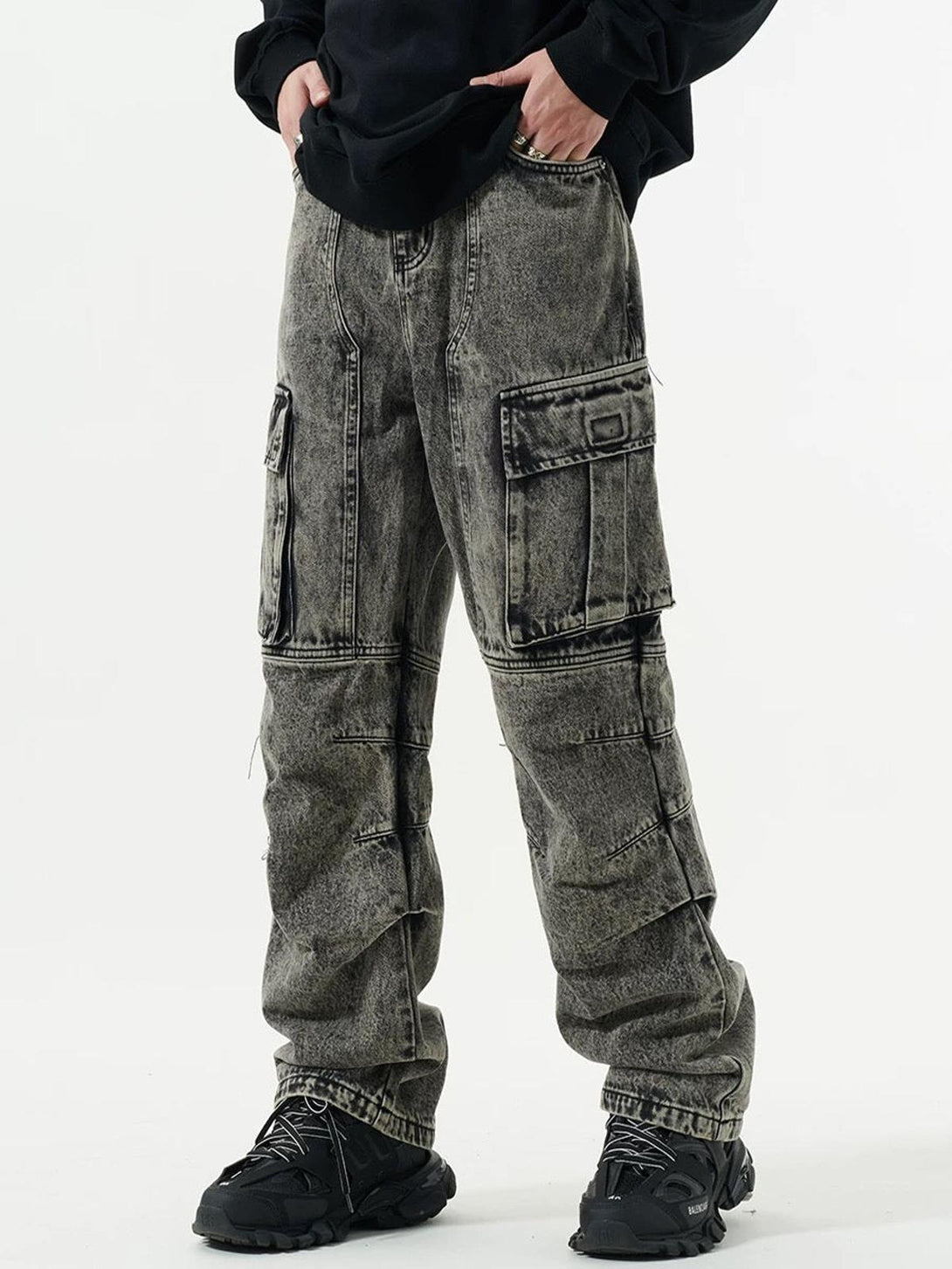 Model wearing washed multi-pocket cargo jeans by TALISHKO, showcasing urban street style.