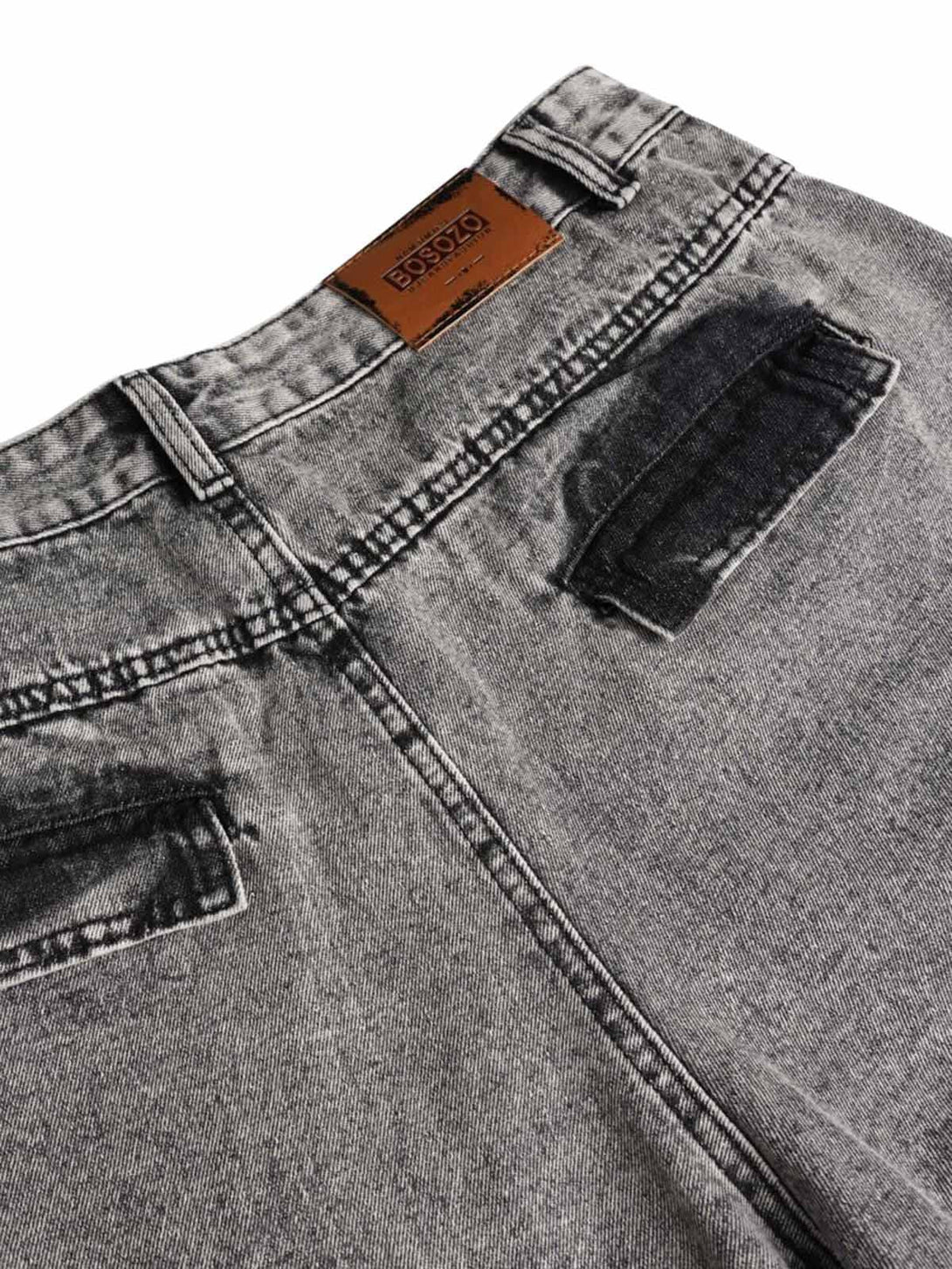 A close-up of gray washed cargo jeans by TALISHKO, highlighting the back pocket details.