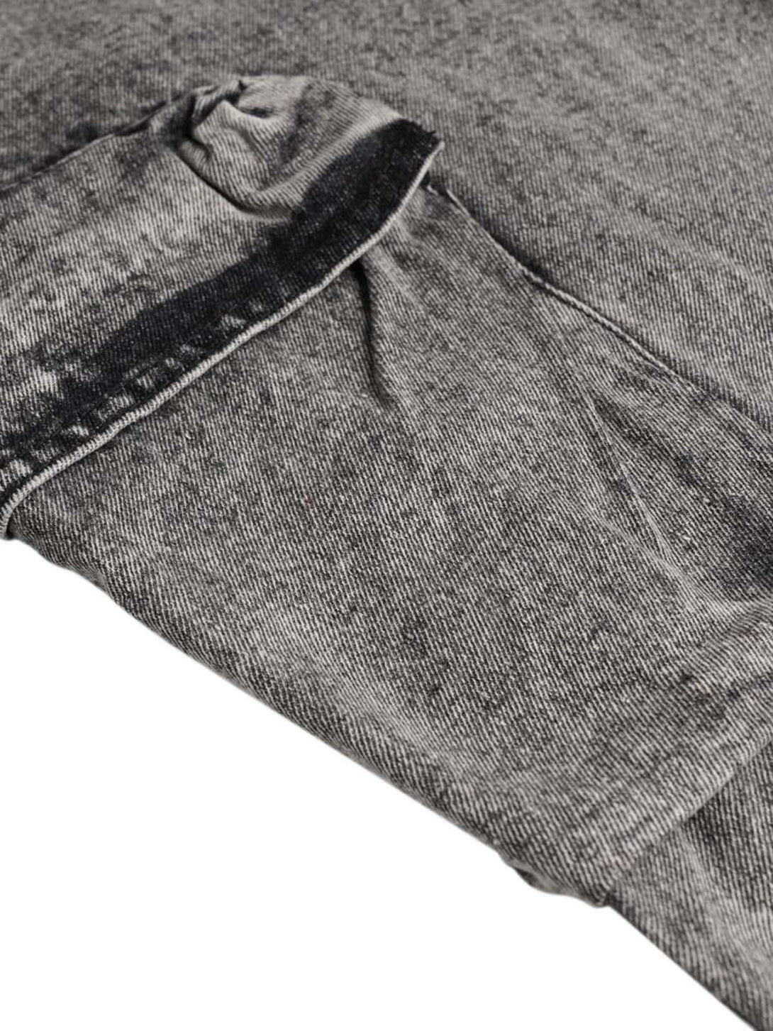 A detailed look at the washed fabric and pocket design of TALISHKO cargo jeans.