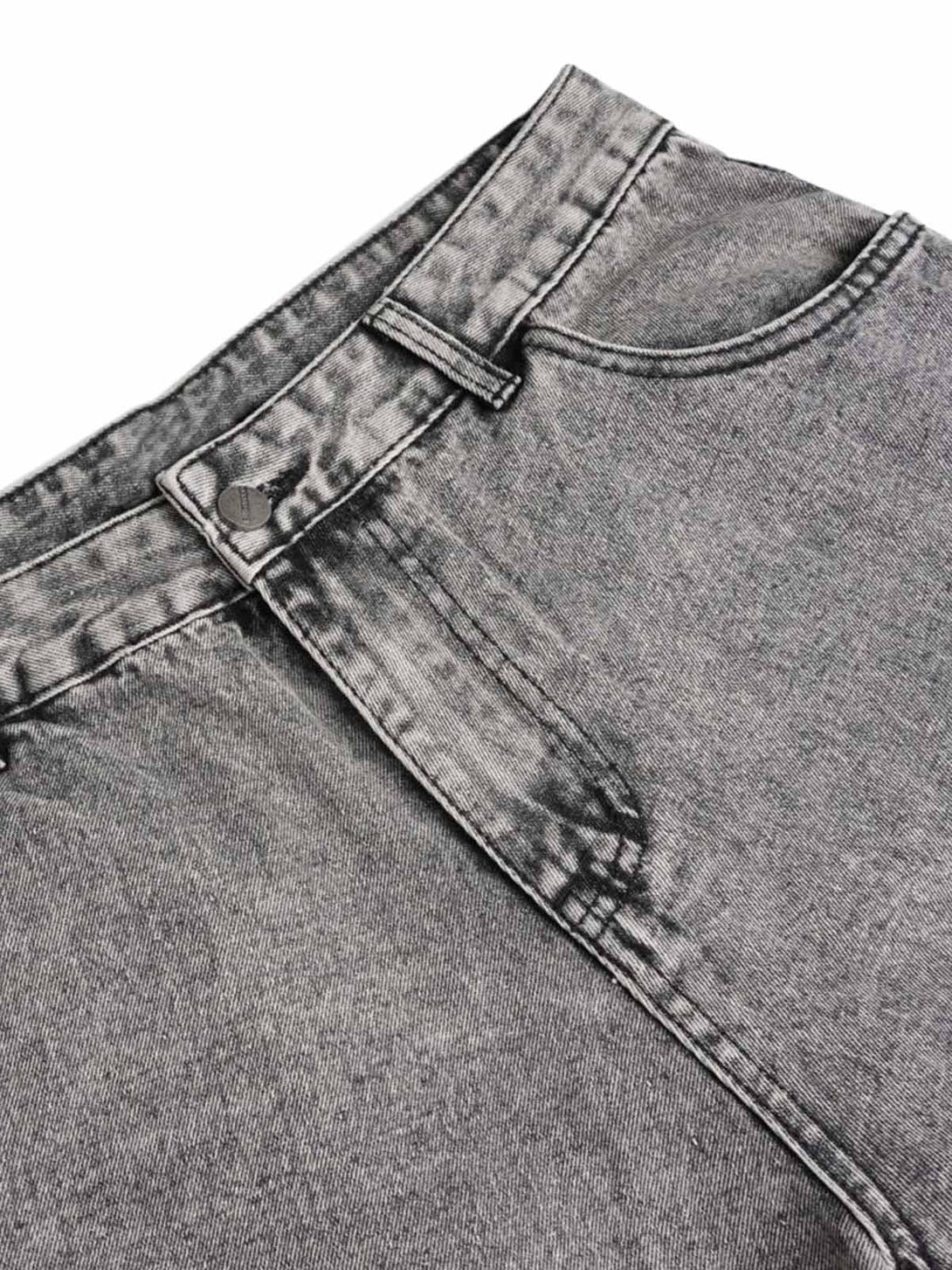 Detailed fabric and stitching of washed cargo jeans by TALISHKO, highlighting the unique texture.