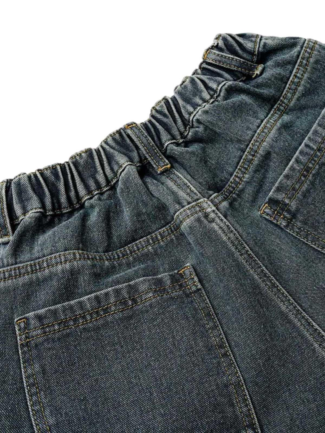 A close-up of TALISHKO's washed denim cargo jorts, highlighting the elastic waistband design.