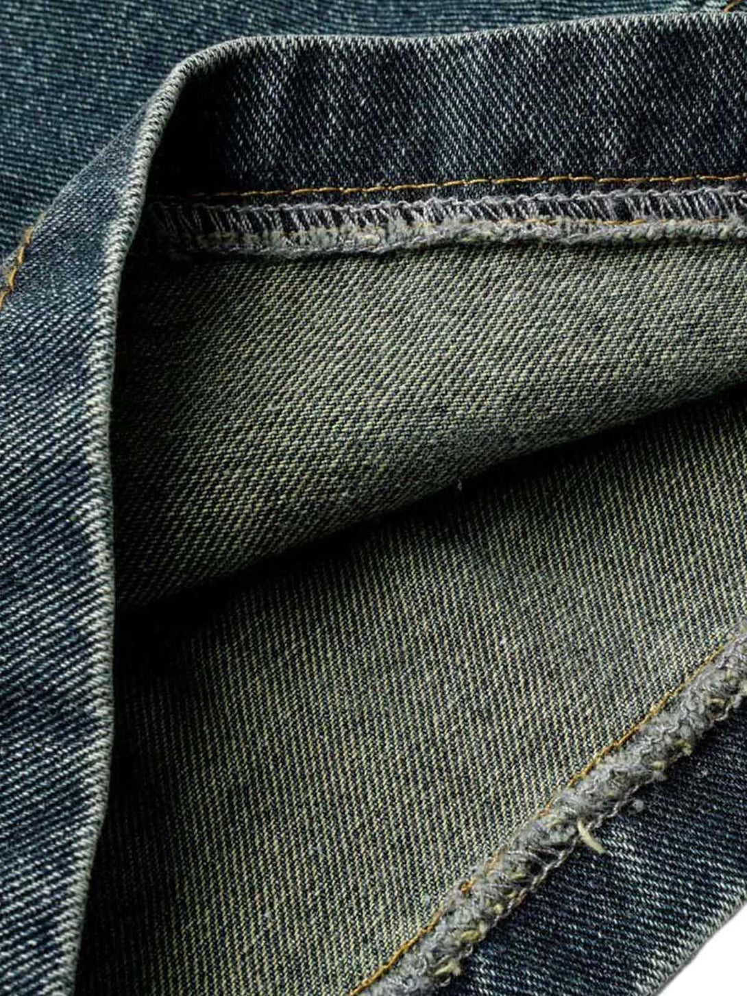 Detailed fabric and stitching of washed denim cargo jorts by TALISHKO.