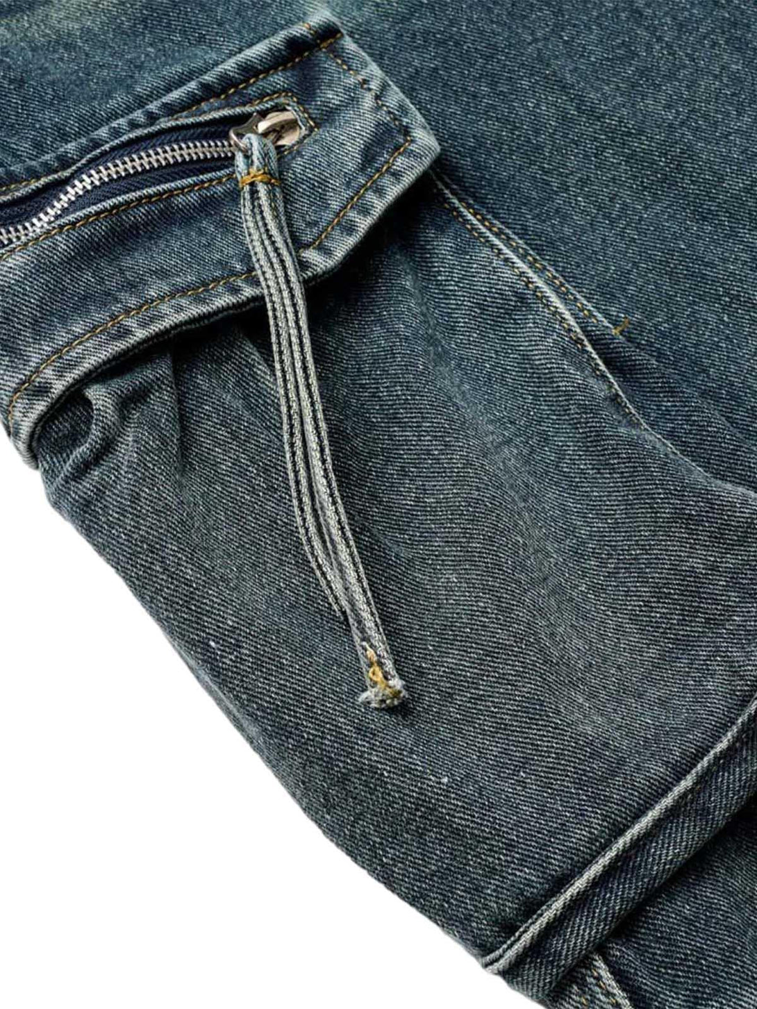 Focusing on TALISHKO's washed denim cargo jorts, highlighting the zipper pocket detail.