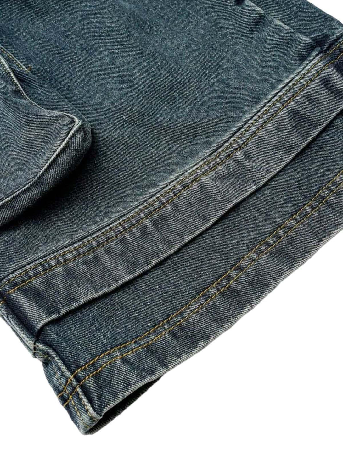 A close-up showcasing the stitching detail on TALISHKO's washed denim cargo jorts.